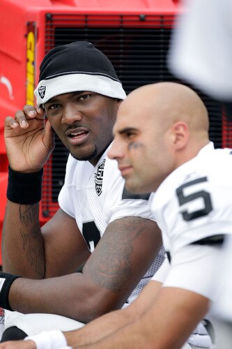 KANSAS CITY, MO - SEPTEMBER 20:  Quarterback JaMarcus Russell #2 of the Oakland Raiders talks with Bruce Gradkowski #5 on the bench during the game against the Kansas City Chiefs at Arrowhead Stadium on September 20, 2009 in Kansas City, Missouri.  <br /><br /><span class="help">(Photo by Jamie Squire/Getty Images)</span>