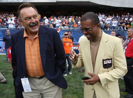 CHICAGO - SEPTEMBER 20: Hall of Fame Chicago Bears Dick Butkus (L) and Gale Sayers share a laugh on the sidelines before a game between the Bears and the Pittsburgh Steelers on September 20, 2009 at Soldier Field in Chicago, Illinois. The Bears defeated the Steelers 17-14. <br /><br /><span class="help">(Photo by Jonathan Daniel/Getty Images)</span>