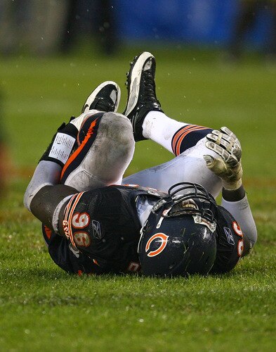 CHICAGO - SEPTEMBER 20: Alex Brown #96 of the Chicago Bears rolls on the ground after suffering an injury in the 4th quarter against the Pittsburgh Steelers on September 20, 2009 at Soldier Field in Chicago, Illinois. The Bears defeated the Steelers 17-14. <br /><br /><span class="help">(Photo by Jonathan Daniel/Getty Images)</span>