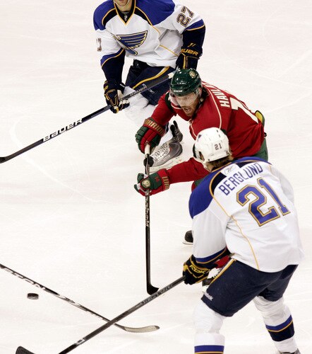 ST. PAUL, MN - SEPTEMBER 24: Martin Havlat #14  of the Minnesota Wild passes the puck between Alex Pietrangelo #27 and Patrik Berglund #21 of St. Louis Blues  at the Xcel Energy Center on September 24, 2009 in St. Paul, Minnesota. The Blues defeated the Wild 4-1. <br /><br /><span class="help">(Photo by Genevieve Ross/Getty Images)</span>