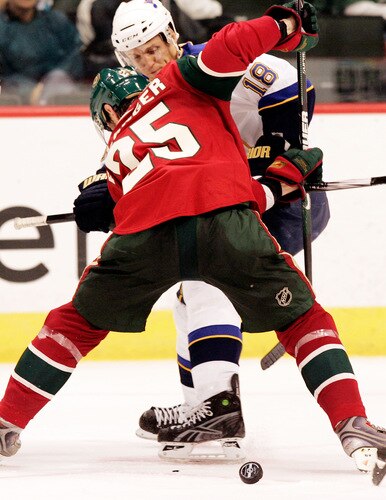 ST. PAUL, MN - SEPTEMBER 24:  Eric Belanger #25 of the Minnesota Wild battles for the puck against Jay McClement #18 of the St. Louis Blues during the third period at the Xcel Energy Center on September 24, 2009 in St. Paul, Minnesota. The Blues defeated the Wild 4-1.  <br /><br /><span class="help">(Photo by Genevieve Ross/Getty Images)</span>