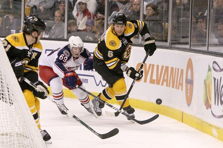 BOSTON, MA - SEPTEMBER 26:  Dennis Wideman #6 of the Boston Bruins looks to pass to teammate Andrew Ference #21 but is pressed by Matt Calvert #69 of the Columbus Blue Jackets at the TD Banknorth Garden during preseason play on September 26, 2009 in Boston, Massachusetts.  <br /><br /><span class="help">(Photo by Jim Rogash/Getty Images)</span>