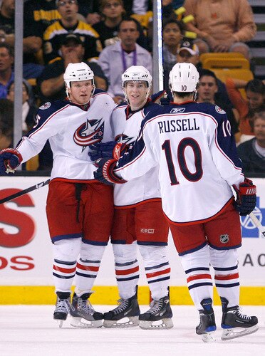 BOSTON, MA - SEPTEMBER 26:  Derek Dorsett #15 of the Columbus Blue Jackets celebrates his goal with his teammates Matt Calvert #69 and Kris Russell #10 against the Boston Bruins during a preseason game at the TD Banknorth Garden on September 26, 2009 in Boston, Massachusetts.  <br /><br /><span class="help">(Photo by Jim Rogash/Getty Images)</span>