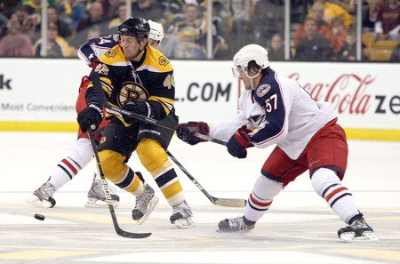 BOSTON, MA - SEPTEMBER 26:  Matt Hunwick #48 of the Boston Bruins feels the pressure from Stefan Legein #57 of the Columbus Blue Jackets during preseason play at the TD Banknorth Garden on September 26, 2009 in Boston, Massachusetts.  <br /><br /><span class="help">(Photo by Jim Rogash/Getty Images)</span>