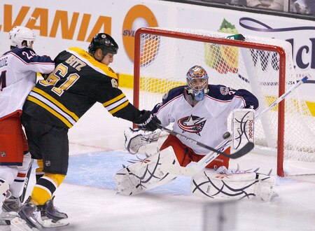 BOSTON, MA - SEPTEMBER 26:  Byron Bitz #61 of the Boston Bruins shoots on goalie Mathieu Garon #32  of the Columbus Blue Jackets during preseason play at the TD Banknorth Garden on September 26, 2009 in Boston, Massachusetts.  <br /><br /><span class="help">(Photo by Jim Rogash/Getty Images)</span>