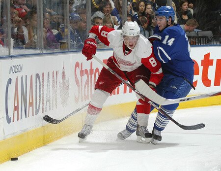 TORONTO, ON - SEPTEMBER 26:  Matt Stajan #14 of the Toronto Maple Leafs knocks Justin Abdelkader #8 of the Detroit Red Wings off the puck in a pre-season game on September 26, 2009 at the Air Canada Centre in Toronto, Ontario. The Leafs defeated the Red Wings 2-1. <br /><br /><span class="help">(Photo by Claus Andersen/Getty Images)</span>