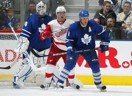 TORONTO, ON - SEPTEMBER 26:  Mike Komisarek #8 and Jonas Gustavsson #50 of the Toronto Maple Leafs sandwich Justin Abdelkader #8 of the Detroit Red Wings in a pre-season game on September 26, 2009 at the Air Canada Centre in Toronto, Ontario. The Leafs defeated the Red Wings 2-1. <br /><br /><span class="help">(Photo by Claus Andersen/Getty Images)</span>
