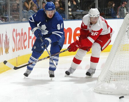 TORONTO, ON - SEPTEMBER 26:  Mikhail Grabovski #84 of the Toronto Maple Leafs clears the puck away from Jakob Kindl #46 of the Detroit Red Wings in a pre-season game  on September 26, 2009 at the Air Canada Centre in Toronto, Ontario. The Leafs defeated the Red Wings 2-1. <br /><br /><span class="help">(Photo by Claus Andersen/Getty Images)</span>