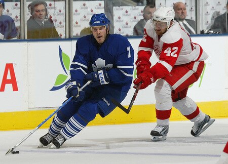 TORONTO, ON - SEPTEMBER 26:  Ian White #7 of the Toronto Maple Leafs takes a stick check from Mattias Ritola #42 of the Detroit Red Wings in a pre-season game  on September 26, 2009 at the Air Canada Centre in Toronto, Ontario. The Leafs defeated the Red Wings 2-1. <br /><br /><span class="help">(Photo by Claus Andersen/Getty Images)</span>