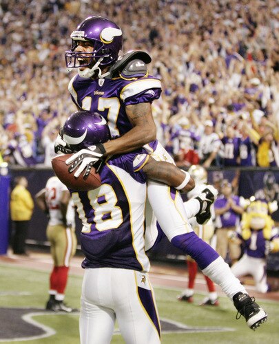 MINNEAPOLIS, MN - SEPTEMBER 27: Greg Lewis #17 of the Minnesota Vikings celebrates with teammate Sidney Rice #18 after catching a 32-yard pass for a touchdown with two seconds on the clock against the San Francisco 49ers at Hubert H. Humphrey Metrodome on September 27, 2009 in Minneapolis, Minnesota. The Vikings defeated the 49ers 27-24. <br /><br /><span class="help">(Photo by Genevieve Ross/Getty Images)</span>