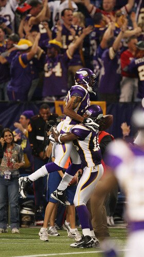 MINNEAPOLIS - SEPTEMBER 27: Sidney Rice #18 of the Minnesota Vikings picks up teammate Greg Lewis #17 after Lewis caught a touchdown pass with 2 seconds on the clock to beat the San Francisco 49ers at the Hubert H. Humphrey Metrodome on September 27, 2009 in Minneapolis, Minnesota. The Vikings defeated the 49ers 27-24. <br /><br /><span class="help">(Photo by Jonathan Daniel/Getty Images)</span>