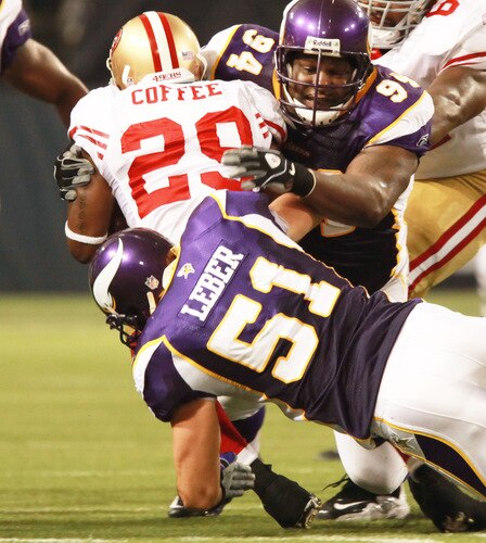 MINNEAPOLIS, MN - SEPTEMBER 27: Glen Coffee #29 of the San Francisco 49ers is stopped by Ben Leber #51 of the Minnesota Vikings along with teammate Pat Williams #94 at Hubert H. Humphrey Metrodome on September 27, 2009 in Minneapolis, Minnesota. The Vikings defeated the 49ers 27-24. <br /><br /><span class="help">(Photo by Genevieve Ross/Getty Images)</span>