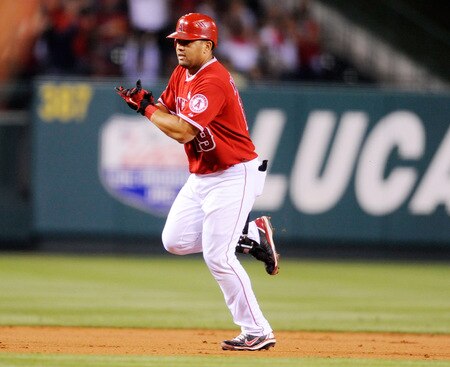 ANAHEIM, CA - SEPTEMBER 28:  Kendry Morales #19  Los Angeles Angels of Anaheim celebrates after hitting a two-run home run to score teammate Vladimir Guerrero # 27 against pitcher Tommy Hunter of the Texas Rangers during first inning of the baseball game at Angel Stadium on September 28, 2009 in Anaheim, California.  <br /><br /><span class="help">(Photo by Kevork Djansezian/Getty Images)</span>