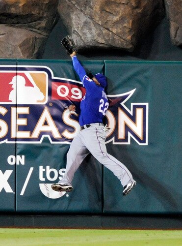 ANAHEIM, CA - SEPTEMBER 28: Marlon Byrd #22 of the Texas Rangers crashes against  the center field in an attempt to catch the two-run home run Kendry Morales #19  Los Angeles Angels of Anaheim during first inning of the baseball game at Angel Stadium on September 28, 2009 in Anaheim, California.  <br /><br /><span class="help">(Photo by Kevork Djansezian/Getty Images)</span>