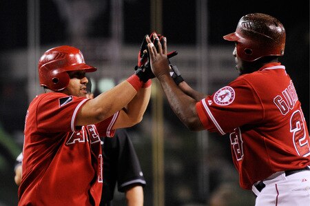 ANAHEIM, CA - SEPTEMBER 28:  Kendry Morales #19 Los Angeles Angels of Anaheim is congratulated by teammate Vladimir Guerrero # 27 after hitting a two-run home run off Tommy Hunter pitcher for the Texas Rangers during first inning of the baseball game at Angel Stadium on September 28, 2009 in Anaheim, California.  <br /><br /><span class="help">(Photo by Kevork Djansezian/Getty Images)</span>