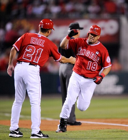 ANAHEIM, CA - SEPTEMBER 28:  Kendry Morales #19 Los Angeles Angels of Anaheim is congratulated by thrid base coach Dino Ebel #21 after hitting a two-run home run off pitcher Tommy Hunter of the Texas Rangers during first inning of the baseball game at Angel Stadium on September 28, 2009 in Anaheim, California.  <br /><br /><span class="help">(Photo by Kevork Djansezian/Getty Images)</span>