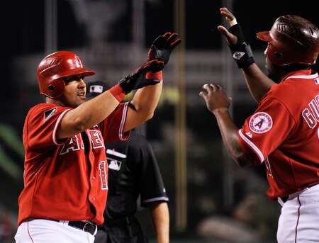 ANAHEIM, CA - SEPTEMBER 28: Kendry Morales #19  Los Angeles Angels of Anaheim is congratulated by teammate Vladimir Guerrero # 27 after hitting a two-run home run off Tommy Hunter pitcher for the Texas Rangers during first inning of the baseball game at Angel Stadium on September 28, 2009 in Anaheim, California.  <br /><br /><span class="help">(Photo by Kevork Djansezian/Getty Images)</span>
