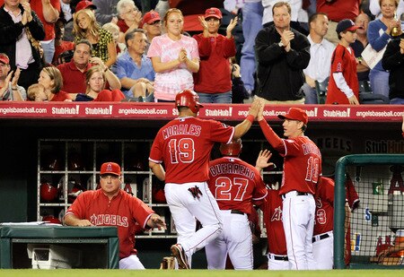 ANAHEIM, CA - SEPTEMBER 28:  Kendry Morales #19 and Vladimir Guerrero #27 of the  Los Angeles Angels of Anaheim are congratulated by his teammates after scoring on Maicer Izturis' a two-run double off pitcher Tommy Hunter of the Texas Rangers during fourth inning of the baseball game at Angel Stadium on September 28, 2009 in Anaheim, California.  <br /><br /><span class="help">(Photo by Kevork Djansezian/Getty Images)</span>