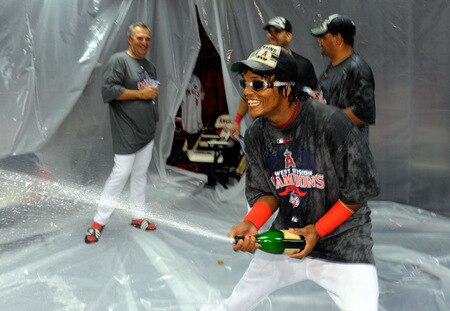 ANAHEIM, CA - SEPTEMBER 28: Erick Aybar #2 of the Los Angeles Angels of Anaheim sprays his teammates as he celebrates after winning the American League West title in their game against the Texas Rangers at Angel Stadium on September 28, 2009 in Anaheim, California. <br /><br /><span class="help">(Photo by Kevork Djansezian/Getty Images)</span>