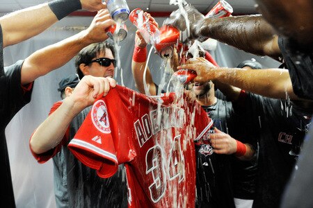 ANAHEIM, CA - SEPTEMBER 28:  A bat boy holds up the jersey of late teammate pitcher Nick Adenhart #34 of the Los Angeles Angels of Anaheim as they celebrate after winning the American League West title in their game against the Texas Rangers at Angel Stadium on September 28, 2009 in Anaheim, California. Adenhart was killed in a accident by a drunk driver during the begining of the season.   <br /><br /><span class="help">(Photo by Kevork Djansezian/Getty Images)</span>
