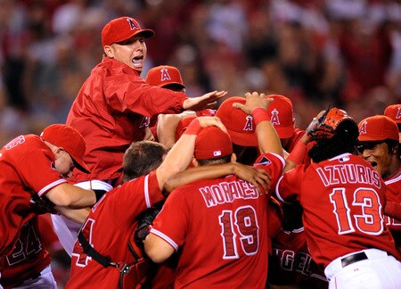 ANAHEIM, CA - SEPTEMBER 28:  Pitcher Ervin Santana (C) of the Los Angeles Angels of Anaheim is mobbed by his teammates after pitching a complete game shut out, 11-0, against the Texas Rangers to win the American League West title at Angel Stadium on September 28, 2009 in Anaheim, California.  <br /><br /><span class="help">(Photo by Kevork Djansezian/Getty Images)</span>