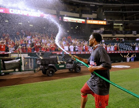 ANAHEIM, CA - SEPTEMBER 28:  Howie Kendrick #47 of the Los Angeles Angels of Anaheim sprays the fans as he celebrates winning the American League West title during their game against the Texas Rangers at Angel Stadium on September 28, 2009 in Anaheim, California.  <br /><br /><span class="help">(Photo by Kevork Djansezian/Getty Images)</span>