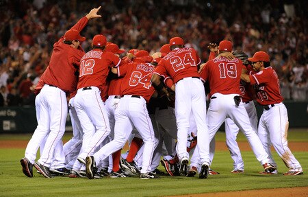 ANAHEIM, CA - SEPTEMBER 28:  Pitcher Ervin Santana (C) of the Los Angeles Angels of Anaheim is mobbed by his teammates after pitching a complete game shut out, 11-0, against the Texas Rangers to win the American League West title at Angel Stadium on September 28, 2009 in Anaheim, California.  <br /><br /><span class="help">(Photo by Kevork Djansezian/Getty Images)</span>