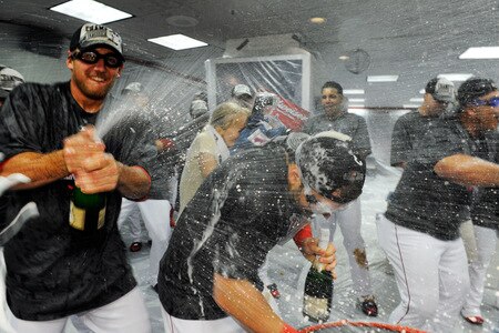 ANAHEIM, CA - SEPTEMBER 28:  A member of the Los Angeles Angels of Anaheim sprays his teammates as he celebrates after winning the American League West title in their game against the Texas Rangers at Angel Stadium on September 28, 2009 in Anaheim, California.  <br /><br /><span class="help">(Photo by Kevork Djansezian/Getty Images)</span>