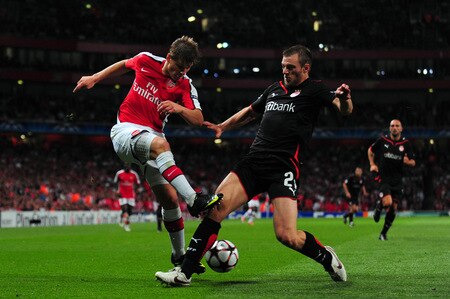 LONDON, ENGLAND - SEPTEMBER 29:  Andrey Arshavin of Arsenal battles for the ball with Avraam Papadopoulo of Olympiakos during the UEFA Champions League Group H match between Arsenal and Olympiakos at the Emirates Stadium on September 29, 2009 in London, England.  <br /><br /><span class="help">(Photo by Mike Hewitt/Getty Images)</span>