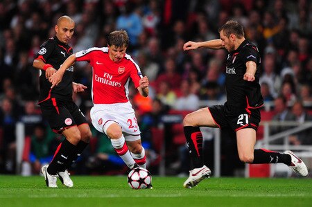 LONDON, ENGLAND - SEPTEMBER 29:  Andrey Arshavin of Arsenal battles for the ball with Avraam Papadopoulo of Olympiakos during the UEFA Champions League Group H match between Arsenal and Olympiakos at the Emirates Stadium on September 29, 2009 in London, England.  <br /><br /><span class="help">(Photo by Mike Hewitt/Getty Images)</span>
