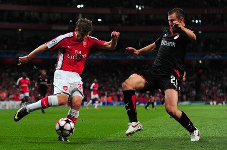 LONDON, ENGLAND - SEPTEMBER 29:  Andrey Arshavin of Arsenal battles for the ball with Avraam Papadopoulo of Olympiakos during the UEFA Champions League Group H match between Arsenal and Olympiakos at the Emirates Stadium on September 29, 2009 in London, England.  <br /><br /><span class="help">(Photo by Mike Hewitt/Getty Images)</span>
