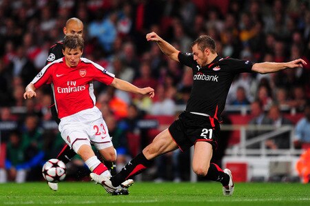 LONDON, ENGLAND - SEPTEMBER 29:  Andrey Arshavin of Arsenal battles for the ball with Avraam Papadopoulo of Olympiakos during the UEFA Champions League Group H match between Arsenal and Olympiakos at the Emirates Stadium on September 29, 2009 in London, England.  <br /><br /><span class="help">(Photo by Mike Hewitt/Getty Images)</span>