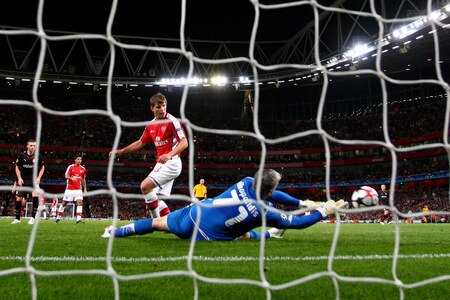 LONDON, ENGLAND - SEPTEMBER 29:  Andrey Arshavin of Arsenal scores the second goal past Olympiakos goalkeeper Antonis Nikopolidis during the UEFA Champions League Group H match between Arsenal and Olympiakos at the Emirates Stadium on September 29, 2009 in London, England.  <br /><br /><span class="help">(Photo by Mike Hewitt/Getty Images)</span>