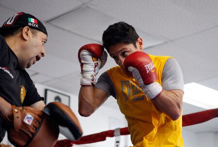 LOS ANGELES, CA - SEPTEMBER 29:  Israel Vasquez Two-time Junior Featherweight World Champion hits the mits with his trainer Rudy Perez during his workout session at Urbina Westside Boxing Gym on September 29, 2009 in Los Angeles, California. Vasquez will return to the ring to face Angel Priolo on October 10, 2009.  <br /><br /><span class="help">(Photo by Jacob de Golish/Getty Images)</span>
