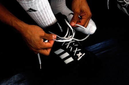 LOS ANGELES, CA - SEPTEMBER 29: Israel Vasquez Two-time Junior Featherweight World Champion ties his shoes before his workout session at Urbina Westside Boxing Gym on September 29, 2009 in Los Angeles, California. Vasquez will return to the ring to face Angel Priolo on October 10, 2009.  <br /><br /><span class="help">(Photo by Jacob de Golish/Getty Images)</span>