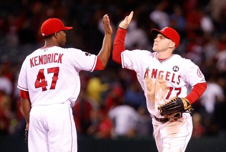 ANAHEIM, CA - SEPTEMBER 29:  Howie Kendrick #47 and Reggie Willits #77 of the Los Angeles Angels of Anaheim exchange high fives following the Angels' victory over the Texas Rangers at Angel Stadium on September 29, 2009 in Anaheim, California. The Angels defeated the Rangers 5-2.  <br /><br /><span class="help">(Photo by Jeff Gross/Getty Images)</span>