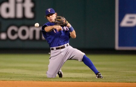 ANAHEIM, CA - SEPTEMBER 29:  Ian Kinsler #5 of the Texas Rangers throws from his knees to get Robb Quinlan of the Los Angeles Angels of Anaheim in the seventh inning at Angel Stadium on September 29, 2009 in Anaheim, California. The Angels defeated the Rangers 5-2.  <br /><br /><span class="help">(Photo by Jeff Gross/Getty Images)</span>