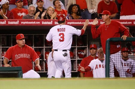 ANAHEIM, CA - SEPTEMBER 29:  Brandon Wood #3 of the Los Angeles Angels of Anaheim is congratulated in the dugout after scoring on a Mike Napoli single in the fourth inning against the Texas Rangers at Angel Stadium on September 29, 2009 in Anaheim, California. The Angels defeated the Rangers 5-2.  <br /><br /><span class="help">(Photo by Jeff Gross/Getty Images)</span>