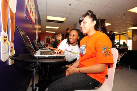 PHOENIX - SEPTEMBER 30:  Temeka Johnson #2 (L) of the Phoenix Mercury assists with a laptop during the WNBA, Toyota and the Phoenix Mercury unveiling of the reading and learning center on September 30, 2009 at the Lincoln Downtown YMCA in Phoenix, Arizona. <br /><br /><span class="help">(Photo by Barry Gossage/NBAE via Getty Images)</span>