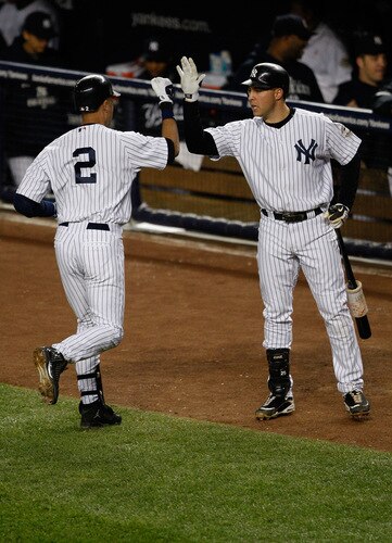 NEW YORK - SEPTEMBER 30:  Derek Jeter #2 is congratulated by Mark Teixeira #25 of the New York Yankees after he hit a solo home run in the first inning against the Kansas City Royals during the game on September 30, 2009 at Yankee Stadium in the Bronx borough of New York City.  <br /><br /><span class="help">(Photo by Jared Wickerham/Getty Images)</span>