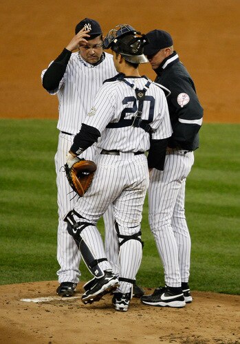 NEW YORK - SEPTEMBER 30: Joba Chamberlain #62, Jorge Posada #20, and pitching coach Dave Eiland #58 of the New York Yankees talk at the mound during the game on September 30, 2009 at Yankee Stadium in the Bronx borough of New York City. <br /><br /><span class="help">(Photo by Jared Wickerham/Getty Images)</span>