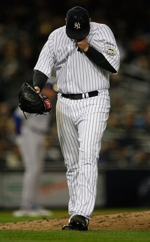 NEW YORK - SEPTEMBER 30:  Joba Chamberlain #62 of the New York Yankees walks off the field after being relieved in the 4th inning during the game on September 30, 2009 at Yankee Stadium in the Bronx borough of New York City.  <br /><br /><span class="help">(Photo by Jared Wickerham/Getty Images)</span>