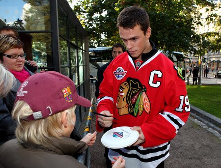 HELSINKI, FINLAND - OCTOBER 01:  Chicago captain Jonathan Toews signs autographs for fans during the 2009 Compuware/NHL Premiere Fan Rally at Esplanade Park on October 1, 2009 in Helsinki, Finland. The Compuware/NHL Premiere Helsinki series will be the first regular-season NHL games ever played in Finland. The Blackhawks and Panthers will face off Friday, Oct. 2, and Saturday, Oct. 3, in Helsinki, Finland at Hartwall Areena.  <br /><br /><span class="help">(Photo by Richard Heathcote/Getty Images for the NHL)</span>