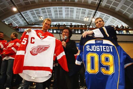 STOCKHOLM, SWEDEN - OCTOBER 01:  Alex Steen of St. Loius Blues (R) and Nicklas Lidstrom (L) of Detroit Red Wings present Swedish Minister of Sport Madeleine Sjostedt (C) with team shirts during the 2009 Compuware/NHL Premier Fan Rally for Detroit Red Wings and St. Loius Blues at Stockholm Central Station on October 1, 2009 in Stockholm, Sweden.  <br /><br /><span class="help">(Photo by Paul Gilham/NHLI via Getty Images)</span>