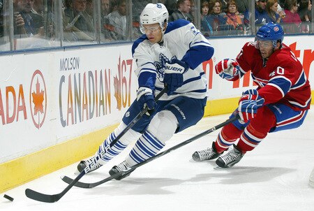TORONTO - OCTOBER 1:  Luke Schenn #2 of the Toronto Maple Leafs clears the puck away from Maxim Lapierre #40 of the Montreal Canadiens in the Maple Leafs home opener on October 1, 2009 at the Air Canada Centre in Toronto, Ontario, Canada.  <br /><br /><span class="help">(Photo by Claus Andersen/Getty Images)</span>