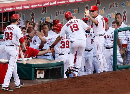 ANAHEIM, CA - OCTOBER 01:  Kendry Morales #19 of the Los Angeles Angels of Anaheim receives high fives from the dugout after hitting a two-run home run against the Texas Rangers in the third inning at Angel Stadium on October 1, 2009 in Anaheim, California. The Rangers defeated the Angels 11-3.  <br /><br /><span class="help">(Photo by Jeff Gross/Getty Images)</span>