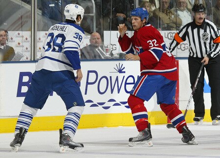 TORONTO - OCTOBER 1:  Jay Rosehill #38 of the Toronto Maple Leafs and Travis Moen #32 of the Montreal Canadiens square off to fight in the Maple Leafs' home opener on October 1, 2009 at the Air Canada Centre in Toronto, Ontario, Canada.  <br /><br /><span class="help">(Photo by Claus Andersen/Getty Images)</span>