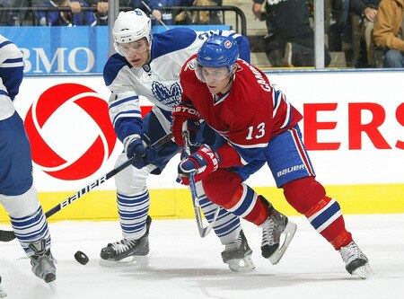 TORONTO - OCTOBER 1:  Luke Schenn #2 of the Toronto Maple Leafs battles with Mike Cammallari #13 of the Montreal Canadiens for the puck in the Maple Leafs' home opener on October 1, 2009 at the Air Canada Centre in Toronto, Ontario, Canada.  <br /><br /><span class="help">(Photo by Claus Andersen/Getty Images)</span>