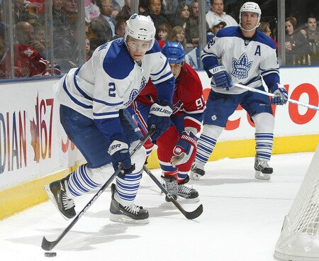 TORONTO - OCTOBER 1:  Luke Schenn #2 of the Toronto Maple Leafs clears the puck away from Scott Gomez #91 of the Montreal Canadiens in the Maple Leafs' home opener on October 1, 2009 at the Air Canada Centre in Toronto, Ontario. The Canadiens defeated the Leafs 4-3 in overtime. <br /><br /><span class="help">(Photo by Claus Andersen/Getty Images)</span>