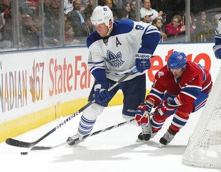 TORONTO - OCTOBER 1:  Brian Gionata #21 of the Montreal Canadiens tries to check Mike Komisarek #8 of the Toronto Maple Leafs in the Maple Leafs' home opener on October 1, 2009 at the Air Canada Centre in Toronto, Ontario. The Canadiens defeated the Leafs 4-3 in overtime. <br /><br /><span class="help">(Photo by Claus Andersen/Getty Images)</span>